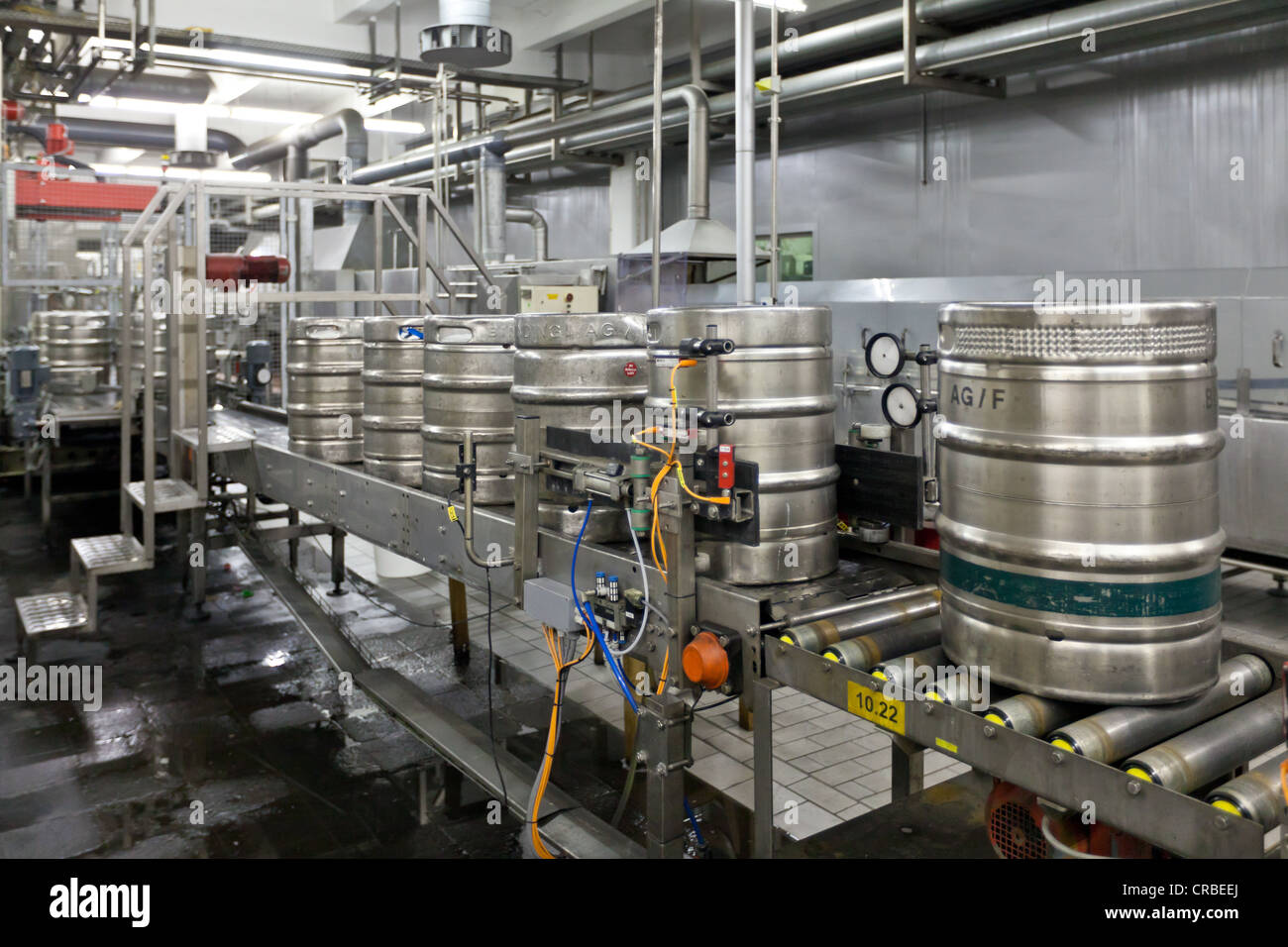 Beer kegs being filled on a conveyor belt, Binding brewery, Frankfurt
