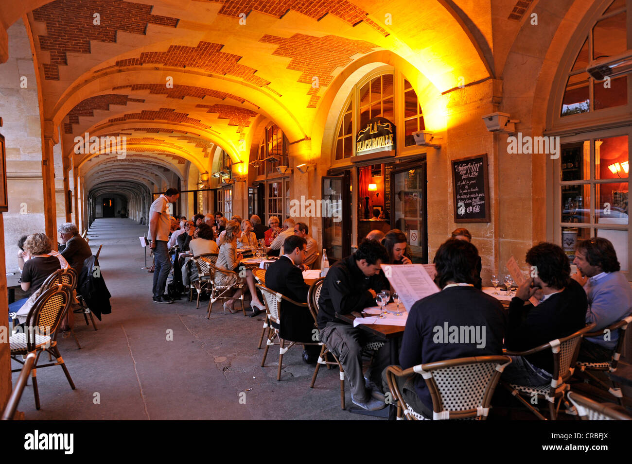 Restaurant Place Royale in the arcades of the Place des Vosges, Jewish quarter of Le Marais, Village St Paul, Paris, France Stock Photo