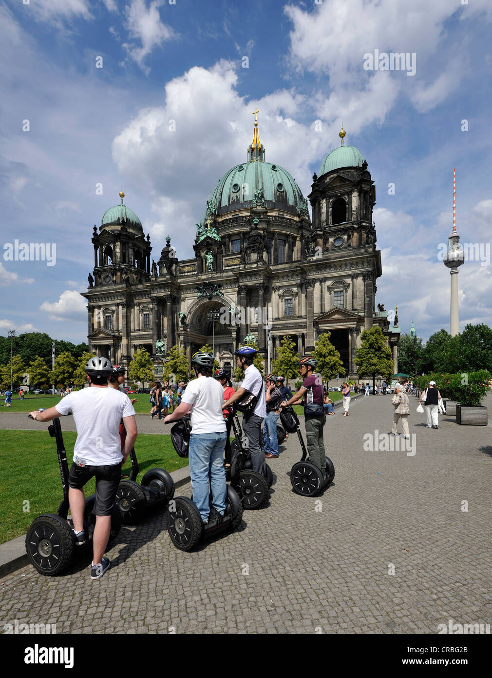 City tour for tourists riding Segways, in front of Berlin Cathedral, Supreme Parish and Collegiate Church in Berlin Stock Photo