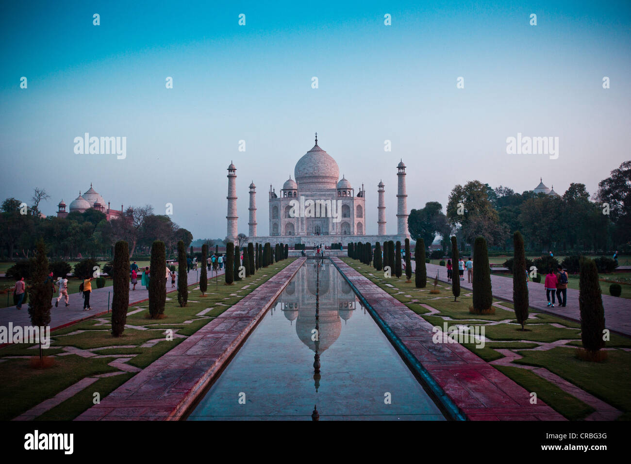 The sun rises over the Taj Mahal, taken from the end of the reflection pool. Stock Photo