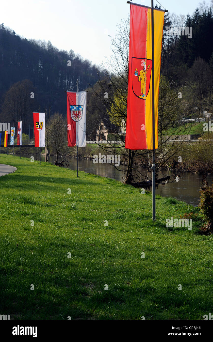 Flags on the waterside promenade of the Wiesent River, flag of the town of Waischenfeld, Upper Franconia, Franconia, Bavaria Stock Photo