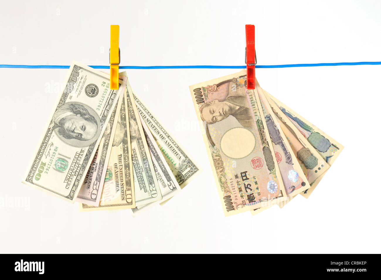 U.S. dollar and Japanese yen bills, notes on clothesline, symbolic image for money laundering, dirty money, exchange rate Stock Photo