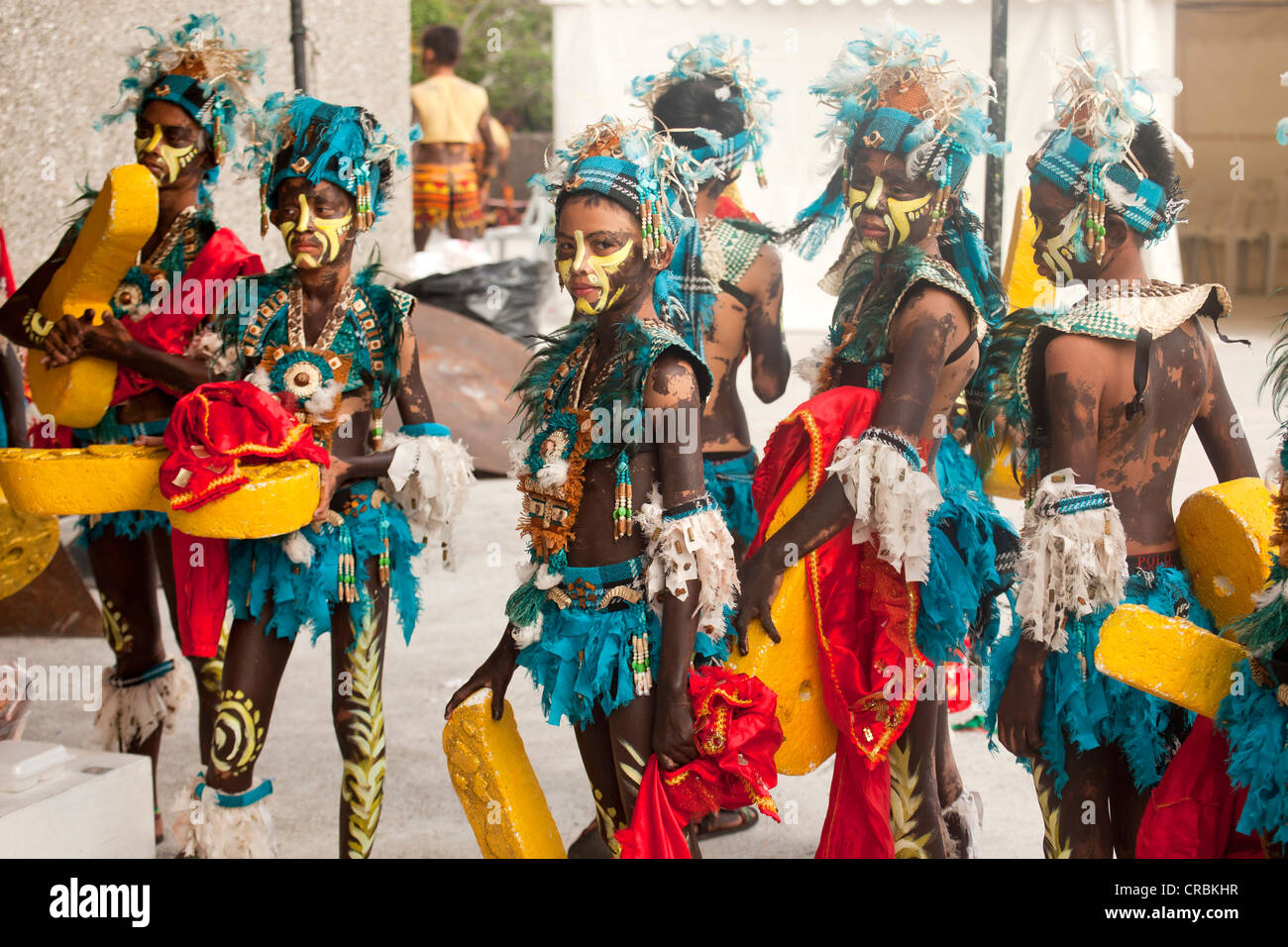 Colourfully painted actors in traditional costume at the Dinagyang Folk Festival in the Cultural Centre of the Philippines, Stock Photo