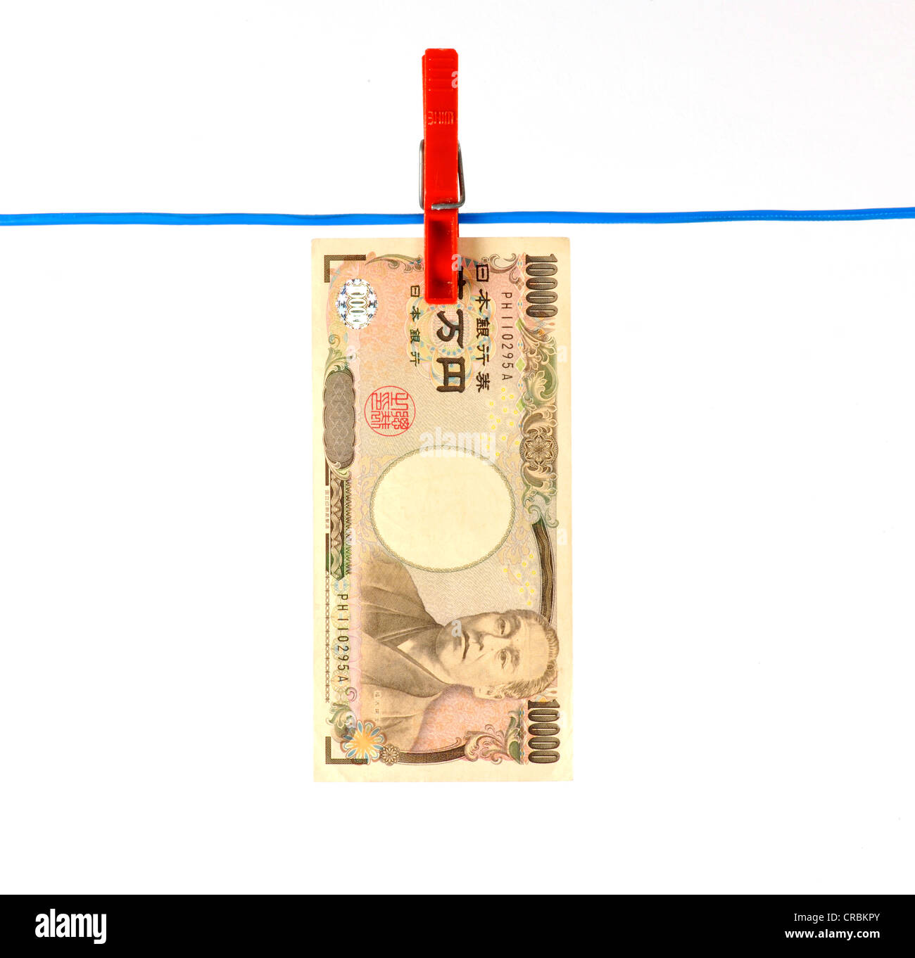 Japanese Yen bank note on a clothesline, symbolic image for money laundering, dirty money Stock Photo