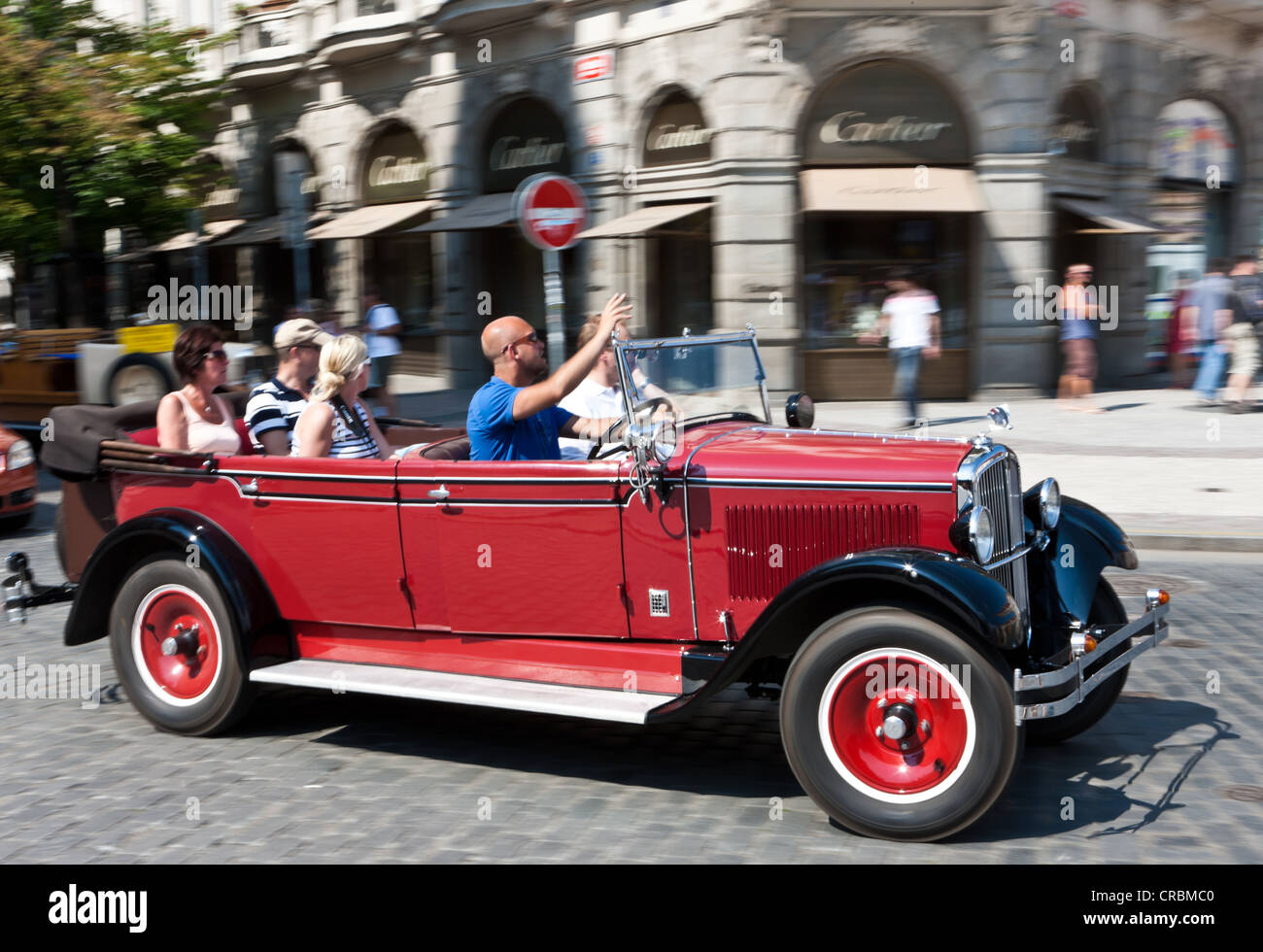 Tourists being driven around the city in a vintage car, Prague, Czech Republic, Europe Stock Photo