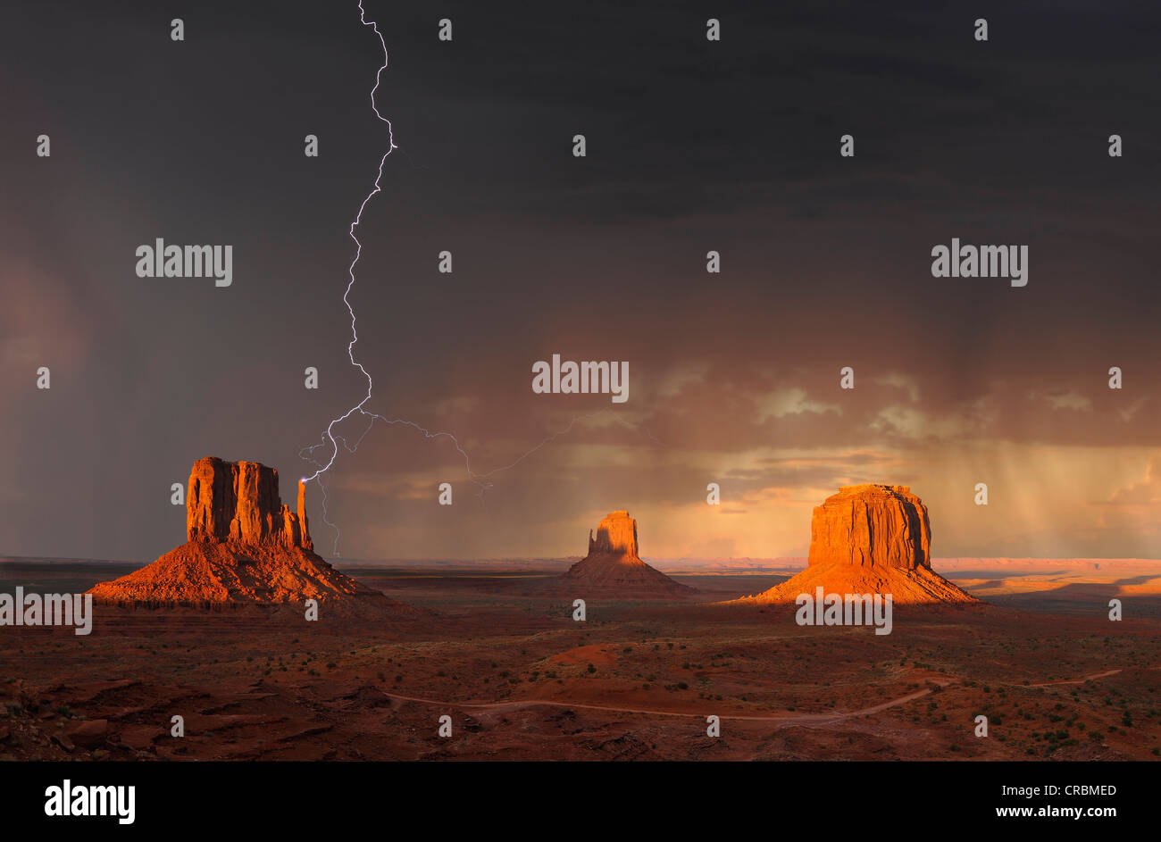 Lightning strikes during a thunderstorm in the evening light, composite, mesas with West Mitten Butte, East Mitten Butte Stock Photo