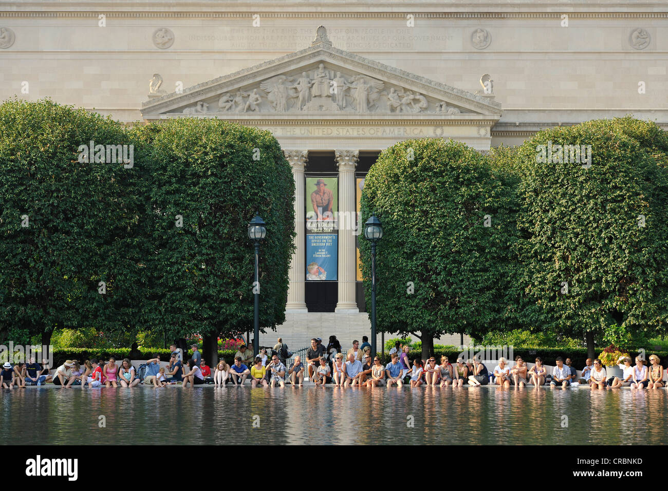 People relaxing on the lake of the National Gallery of Art, Sculpture Garden Museum, Archives of the United States Building at Stock Photo