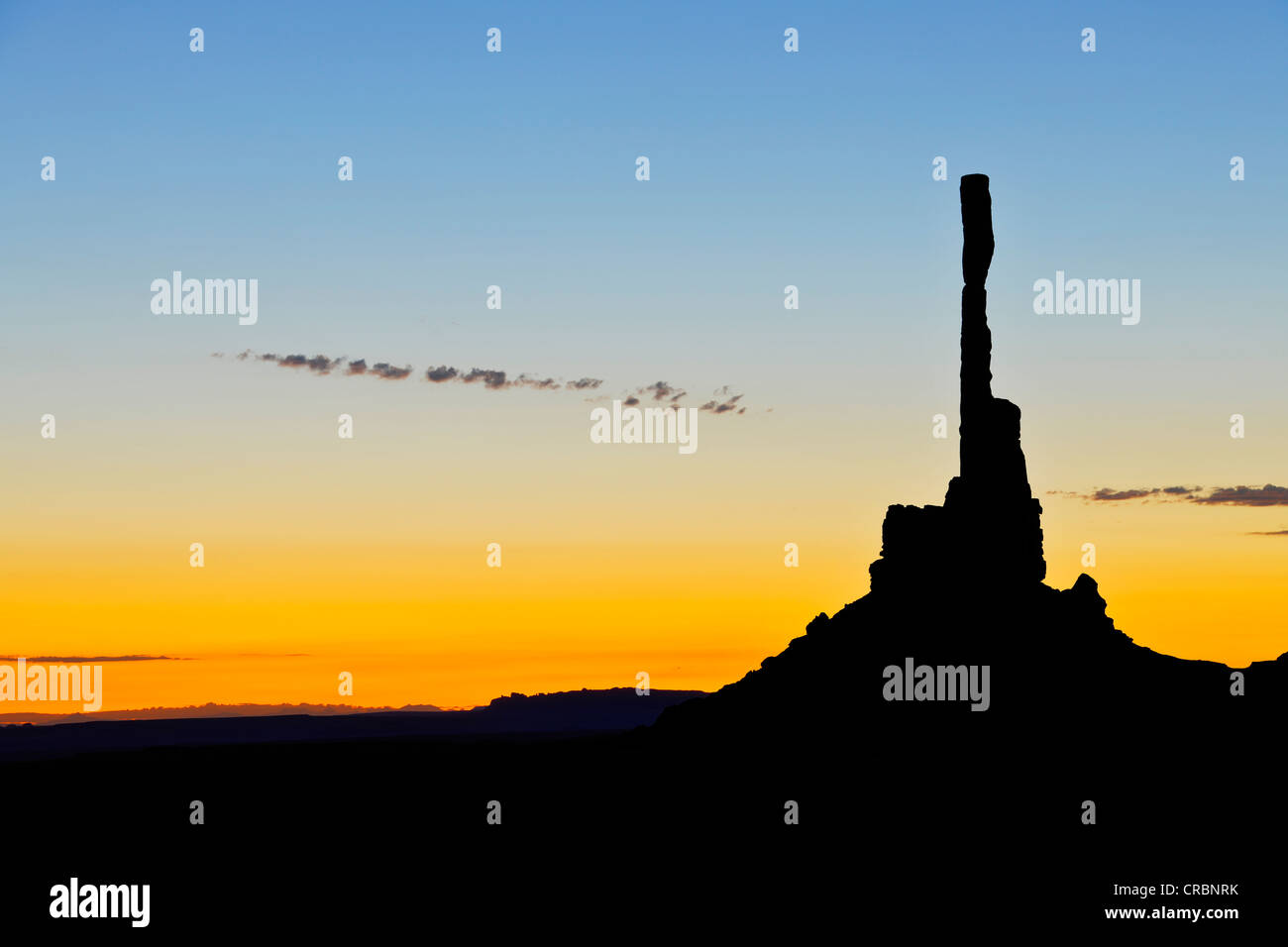 Totem Pole rock formation with backlighting before sunrise, dawn