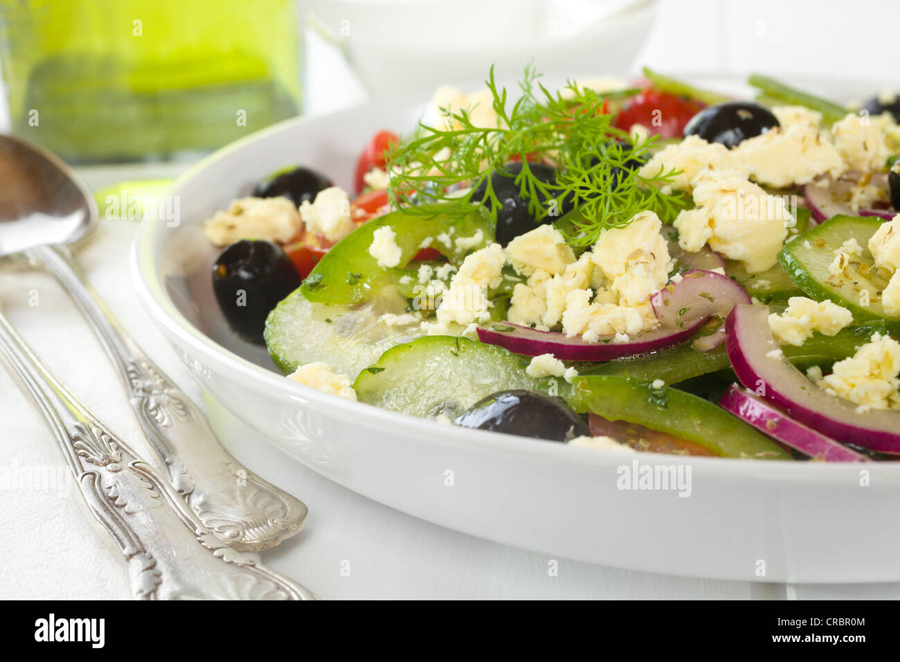 Greek salad, a delicious combination of green capsicum, black olives, cucumber, tomato, red onion, mint, dill and oregano, Stock Photo