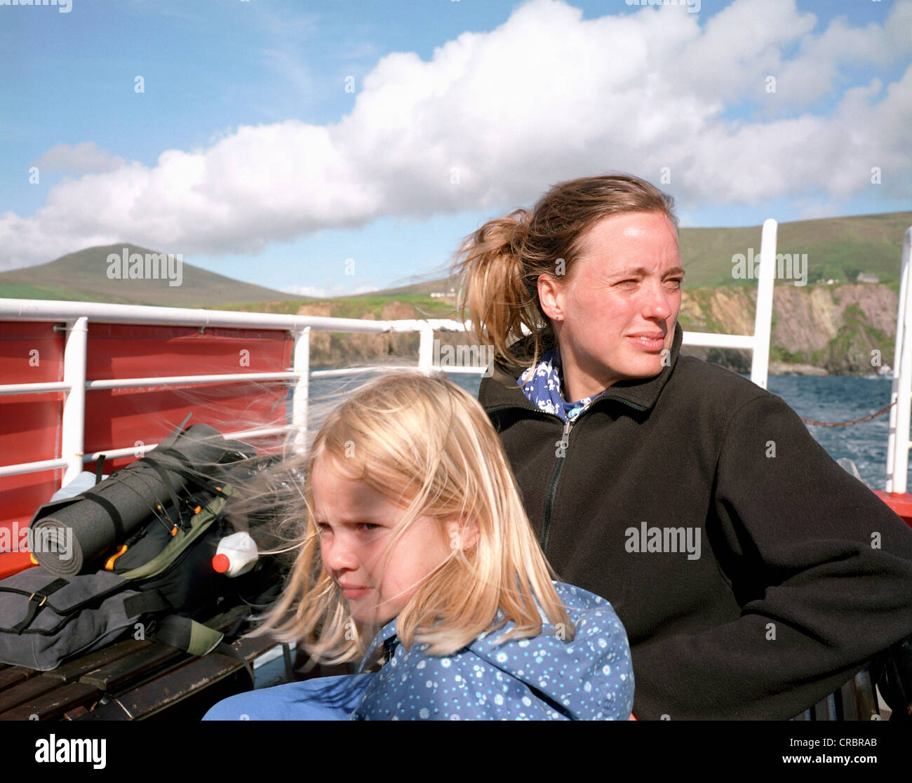 Mother and daughter riding on ferry boat Stock Photo