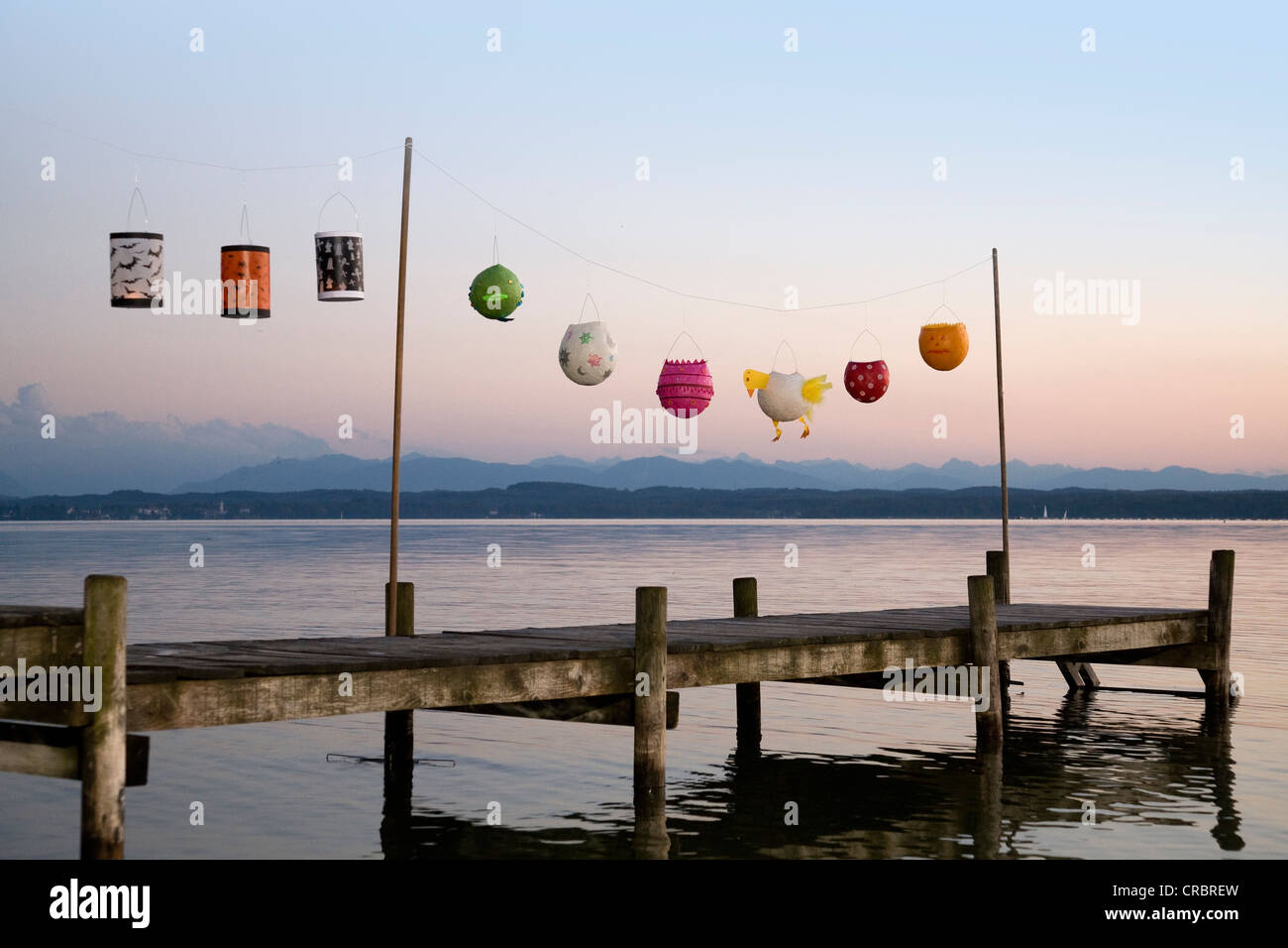 Paper lanterns strung up on wooden pier Stock Photo