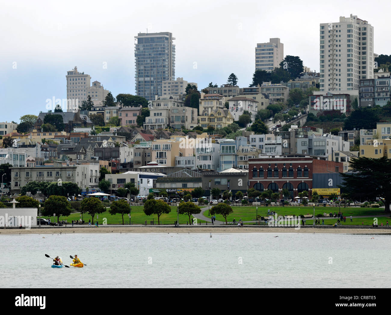 Canoeists in front of the skyline with the Financial District, San Francisco Maritime Historic Park, Fisherman's Wharf, Port Stock Photo