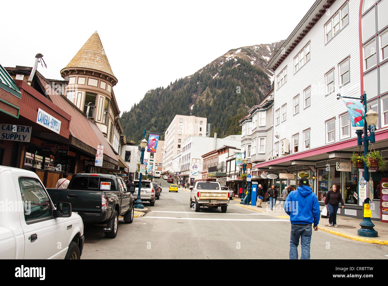 Street scene of Juneau, Alaska with shops, cars, trucks and people
