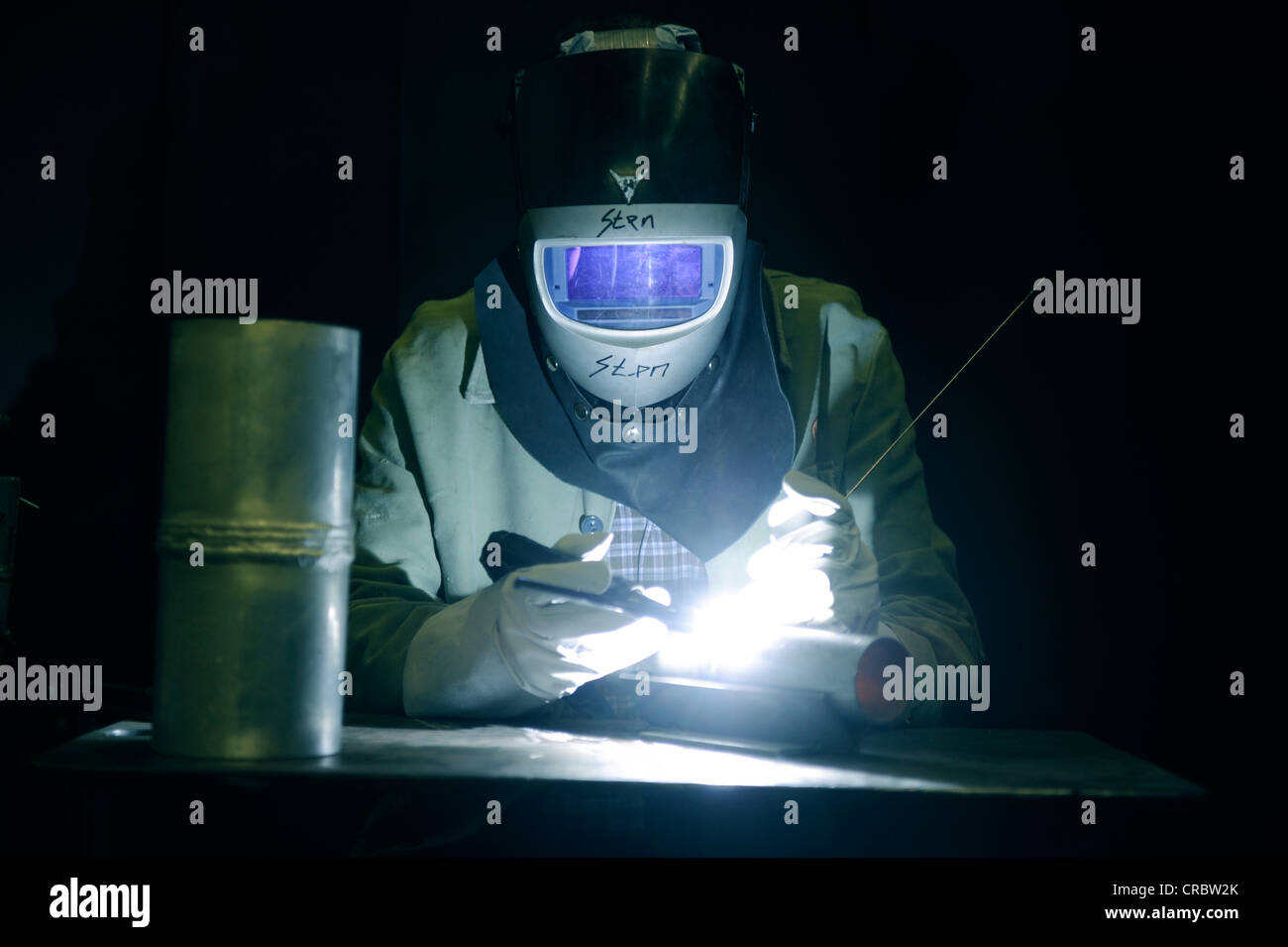 Industrial welder wearing protective gear at work Stock Photo Alamy