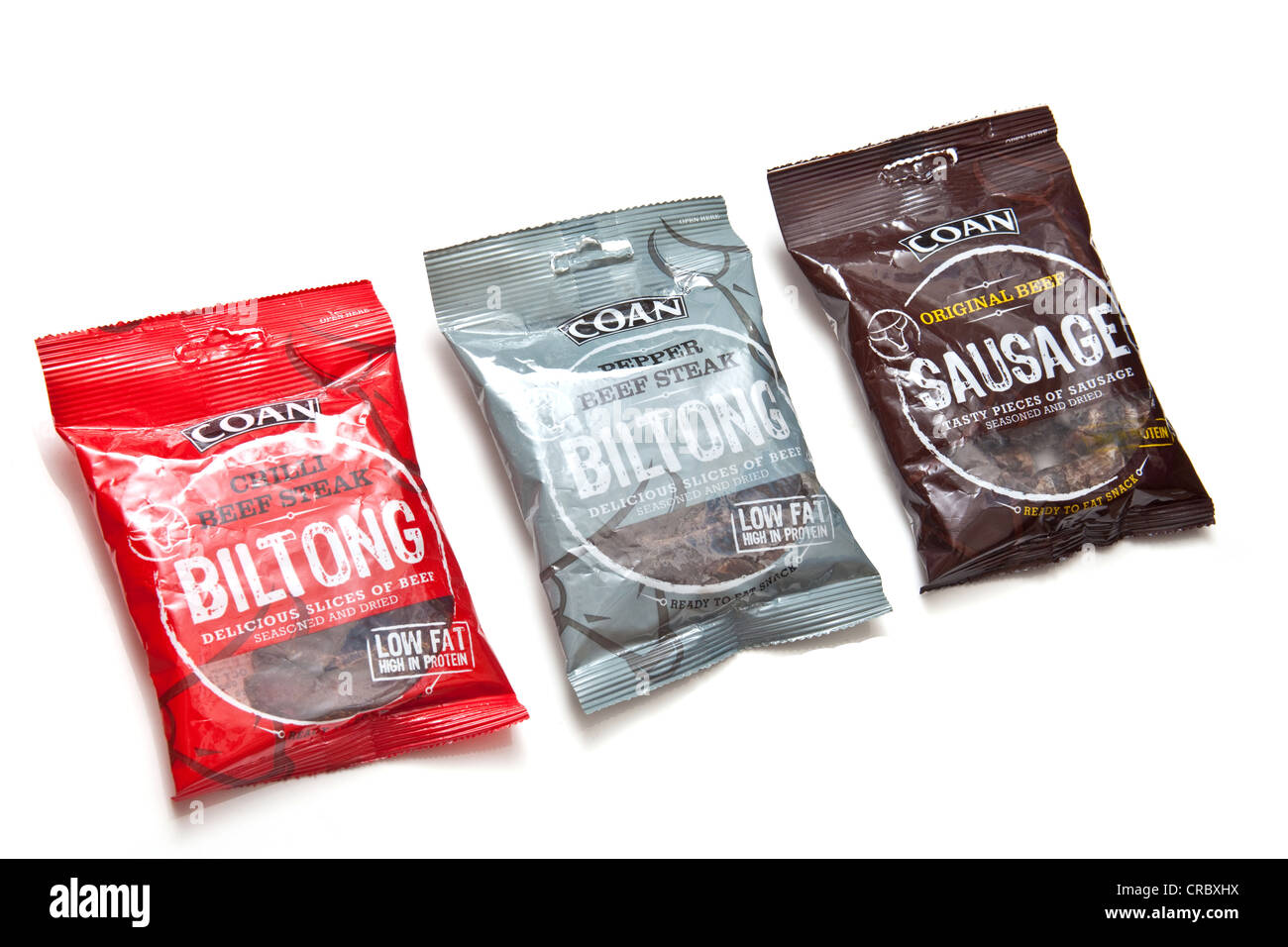 Packets of Coan Biltong (South African beef jerky) isolated on a white studio background Stock