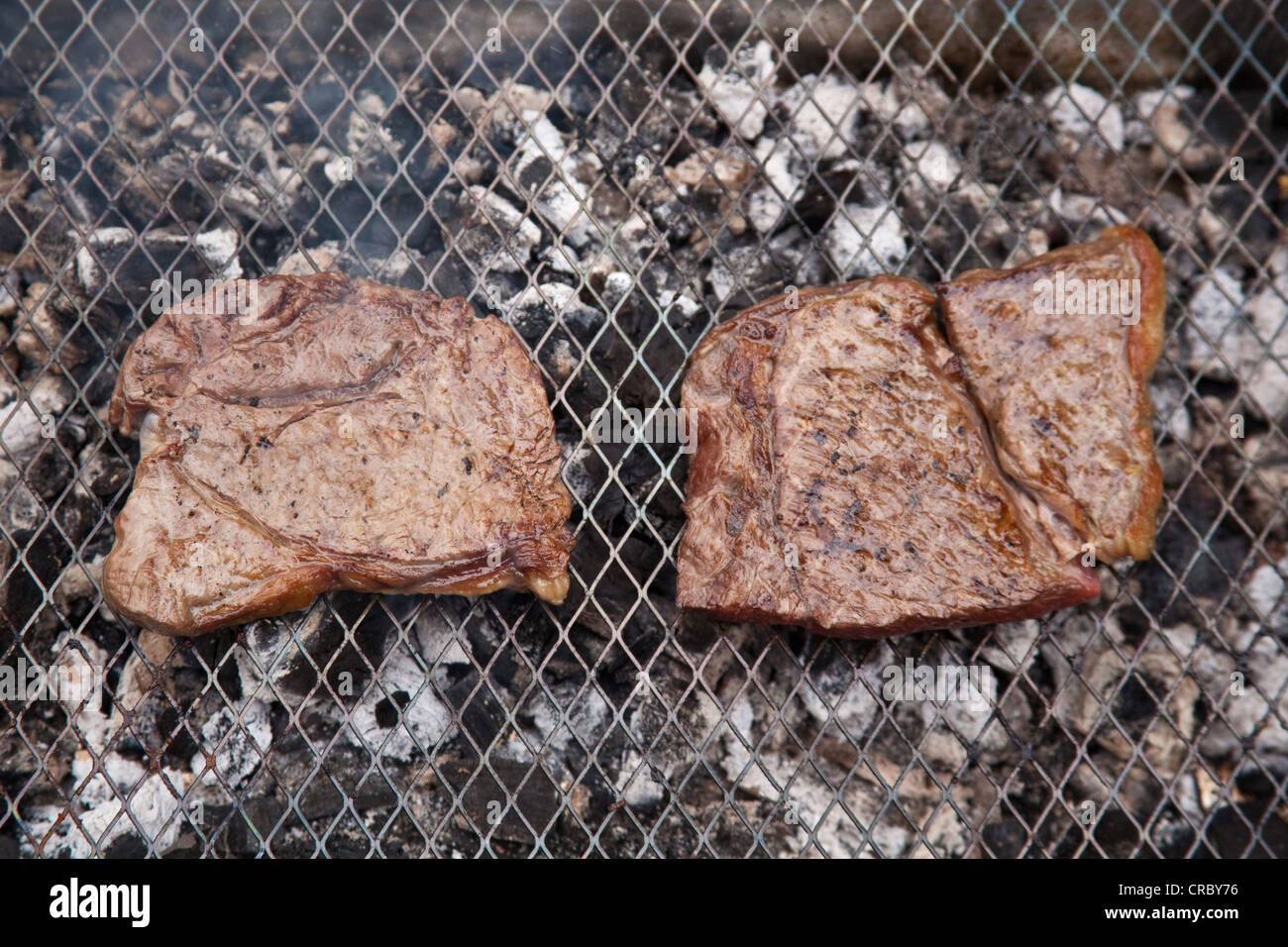 Rump steak cooking on a charcoal barbecue Stock Photo Alamy