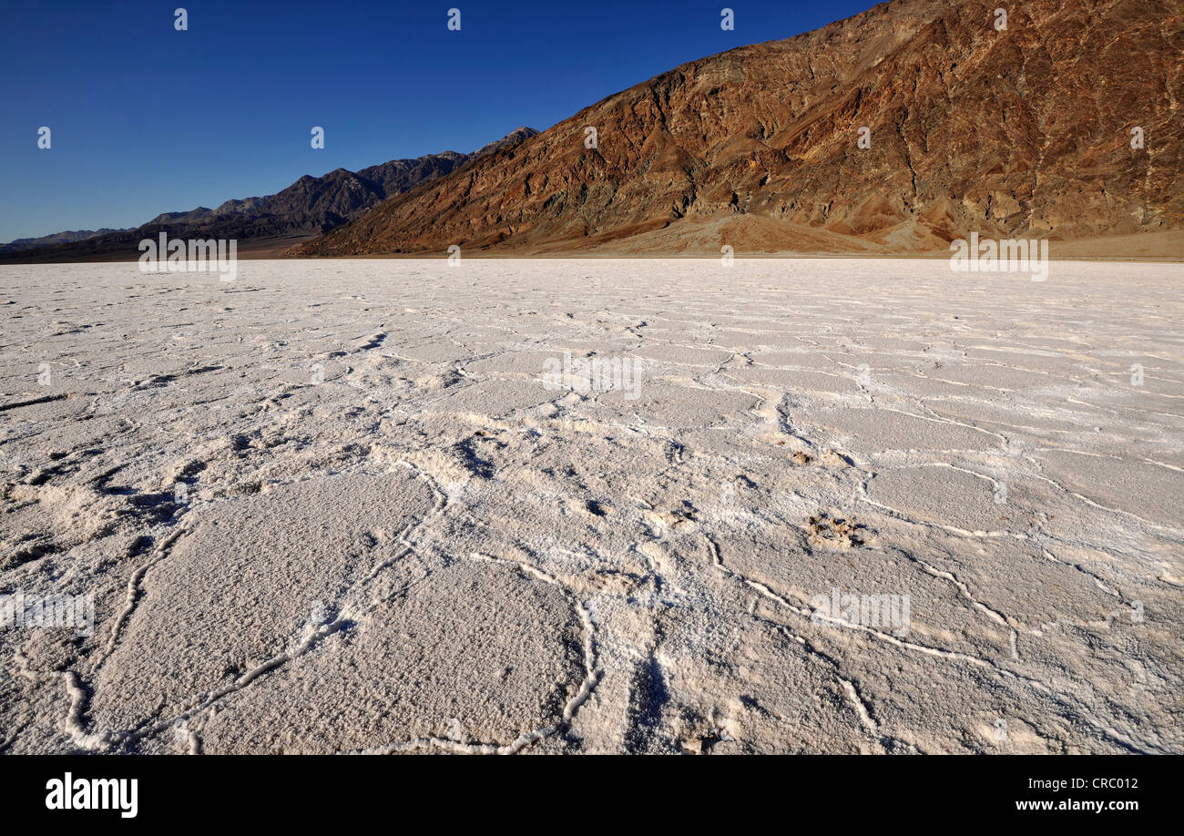 Salt pan, salt crystals, Badwater Basin, Black Mountains at back, Death Valley National Park, Mojave Desert, California, USA Stock Photo