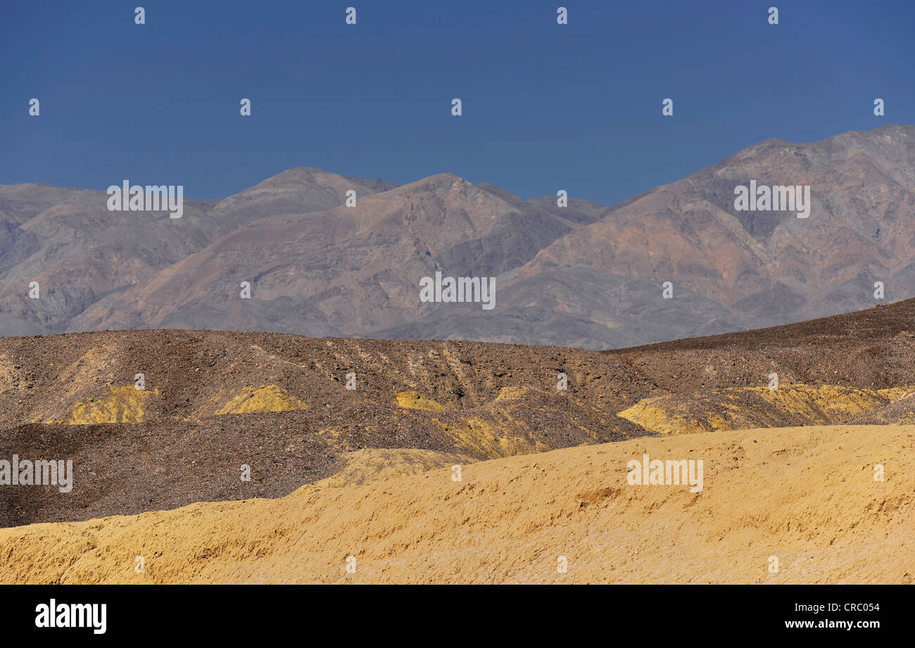 Eroded rock discolored by minerals in the Mustard Canyon, looking towards Panamint Range, Death Valley National Park Stock Photo