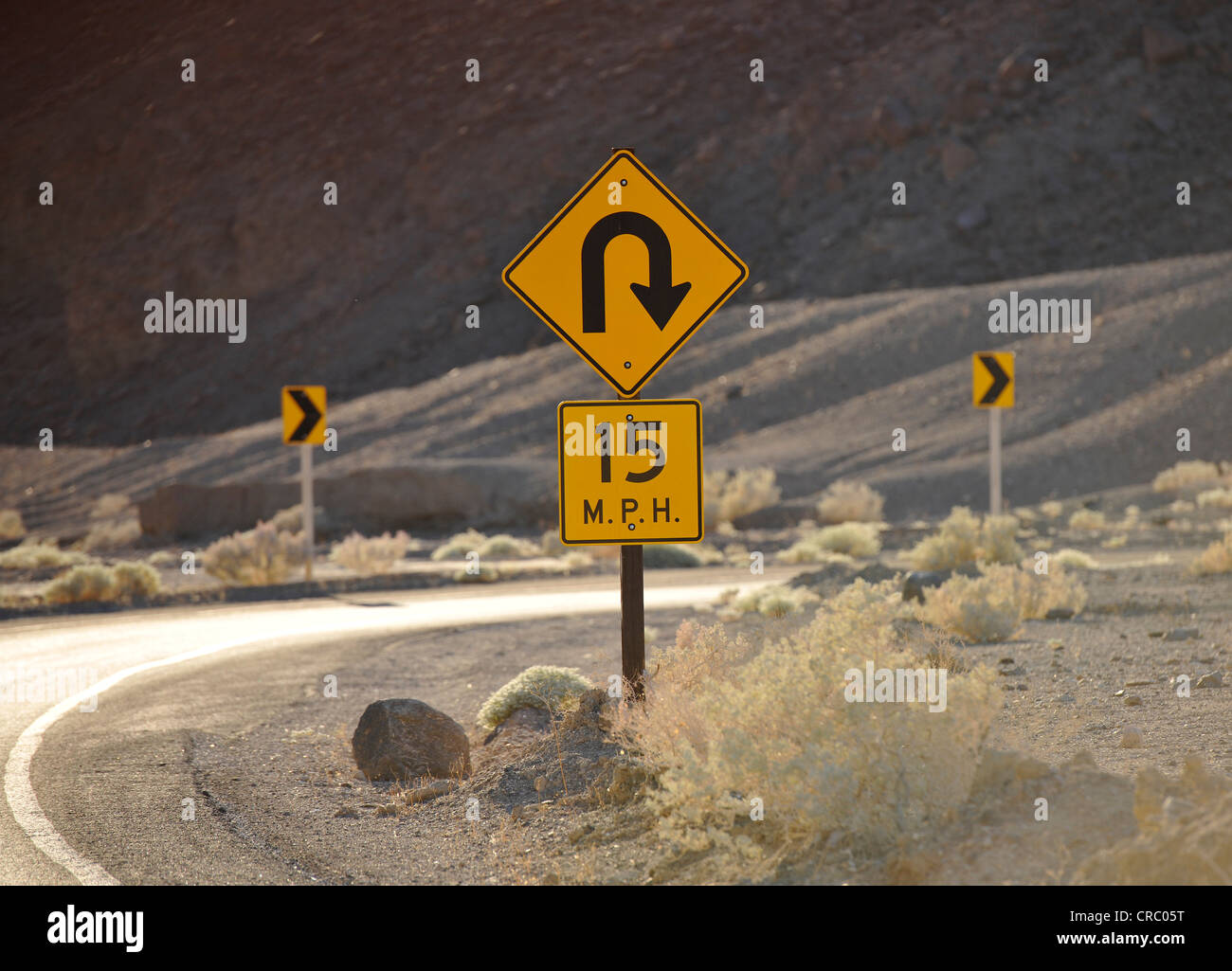 Sharp curve traffic sign, curvy road, Artist's Drive, Death Valley National Park, Mojave Desert, California Stock Photo