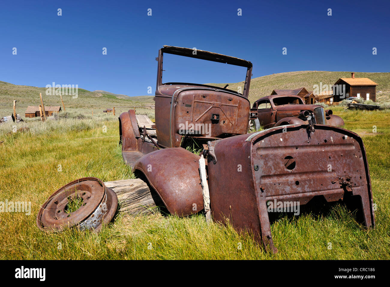 Rusty cars, at the rear, a 1937 Chevrolet Chevy, ghost town of Bodie, a former gold mining town, Bodie State Historic Park Stock Photo