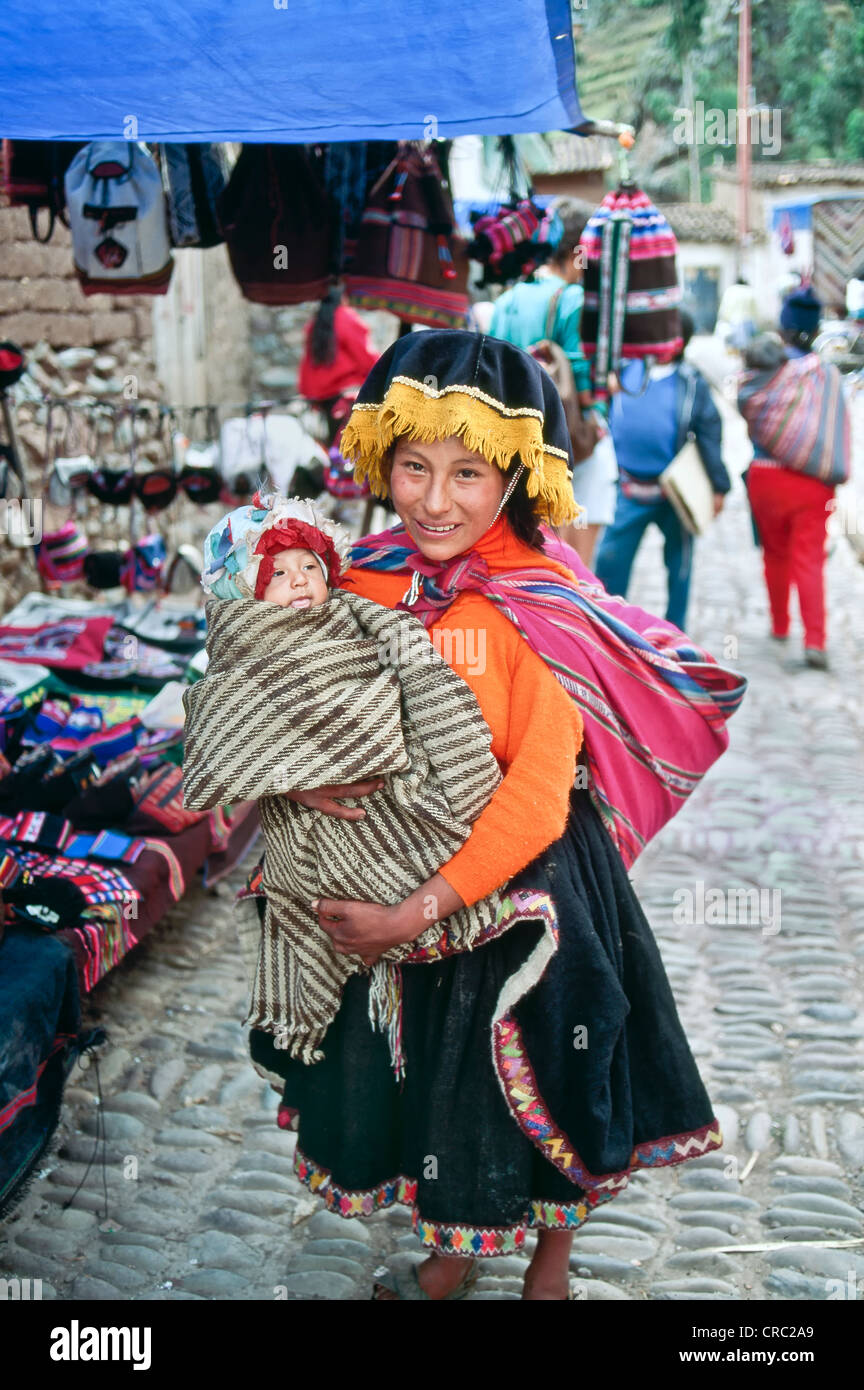 Proud young mother holding infant, Pisac market, Peru. Stock Photo