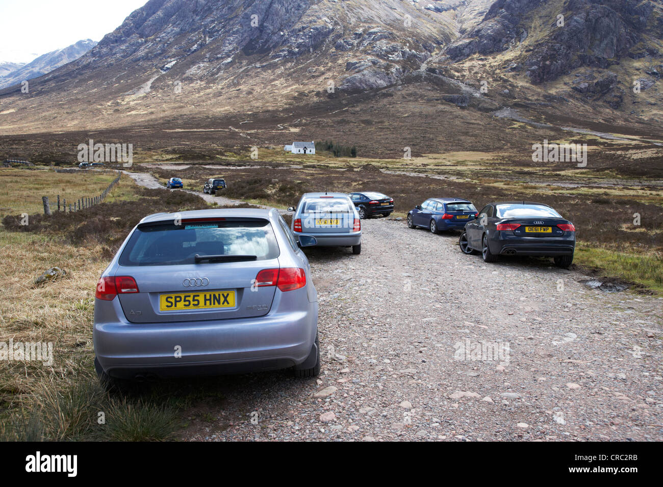 cars parked by walkers on rough path at glen etive glencoe highlands scotland uk Stock Photo