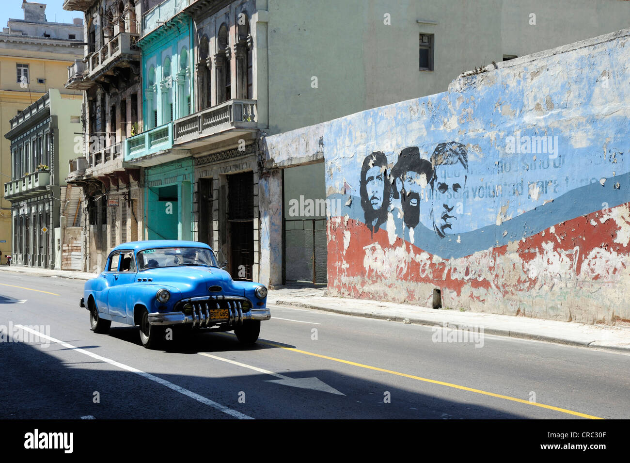 Blue 1950s vintage car, mural painting in the city centre of Havana