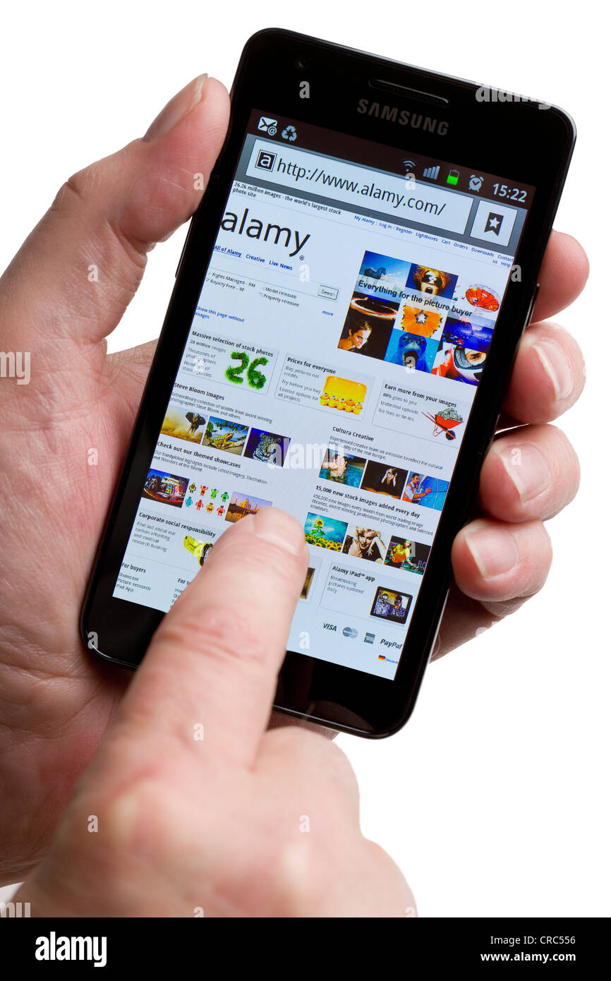 Looking for images at Alamy on a smartphone Stock Photo
