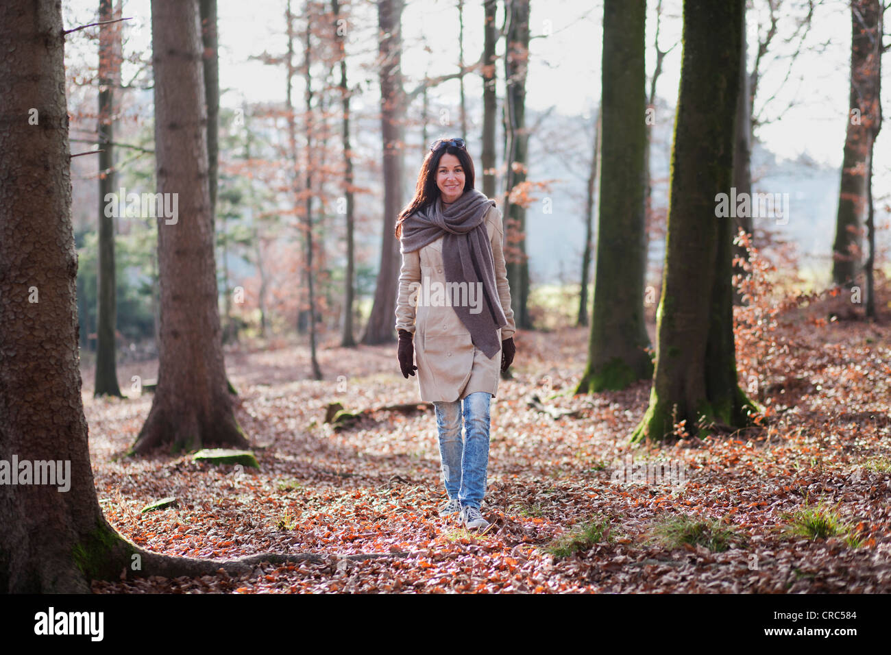 Older woman walking in forest Stock Photo - Alamy