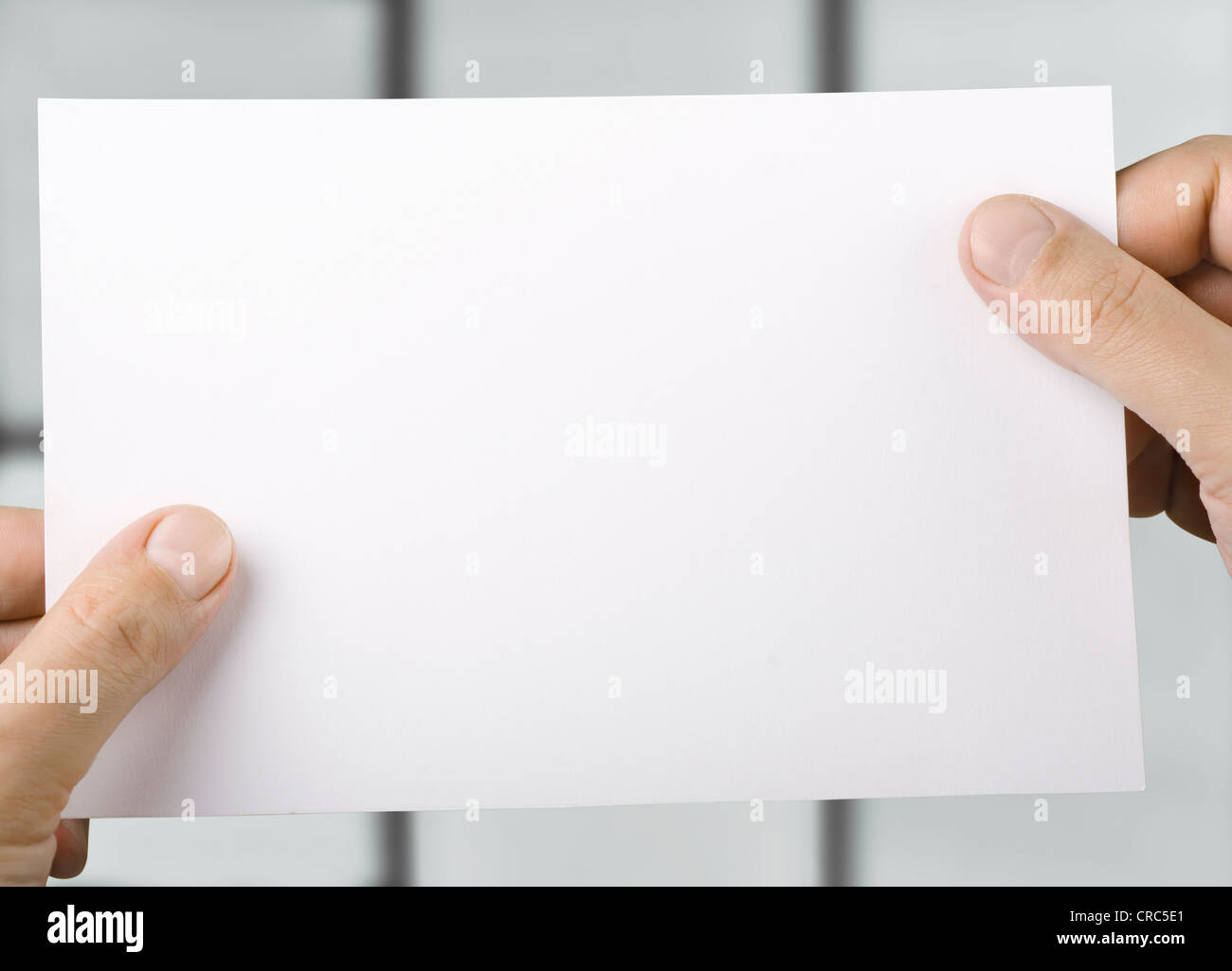 White blank sheet of paper in hands Stock Photo