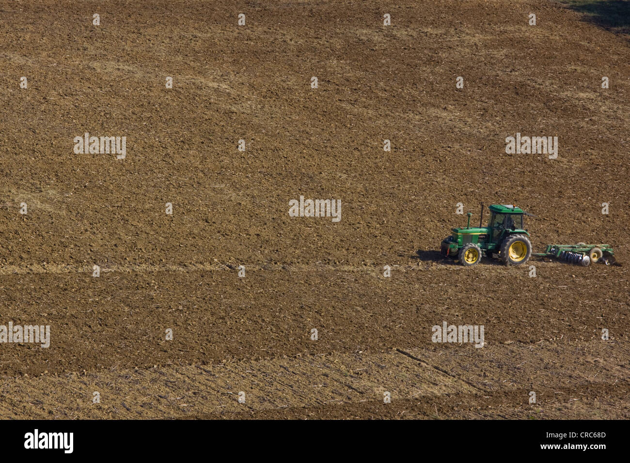 A farmer prepares arable land to lie fallow after the harvest in SW