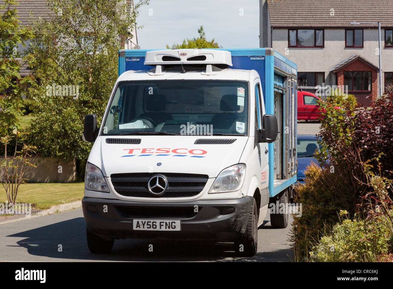 Tesco home delivery van in the street delivering to a residential house in UK Britain Stock Photo