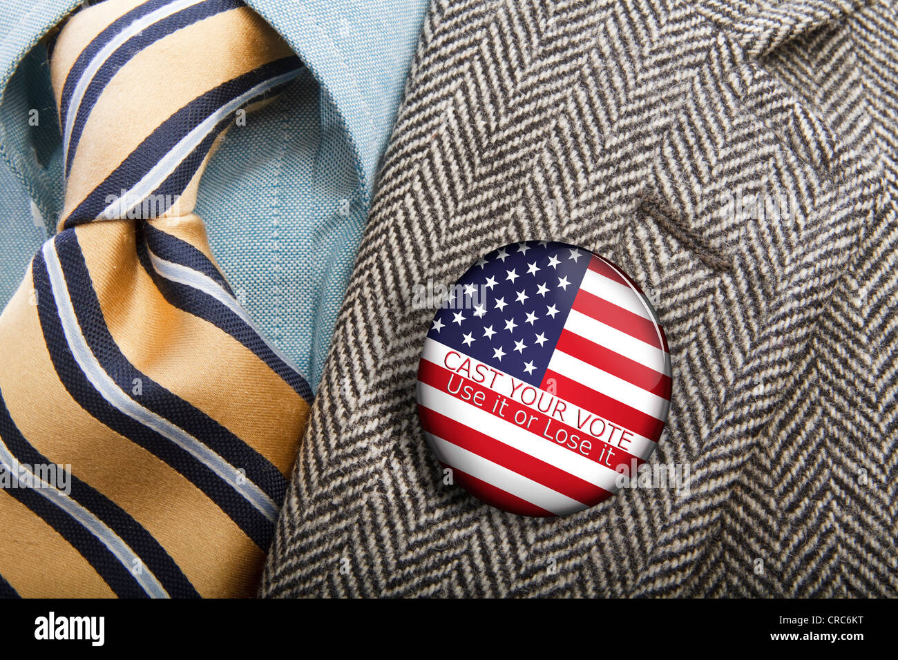 political button pinned to a man's jacket lapel urging people to vote Stock Photo