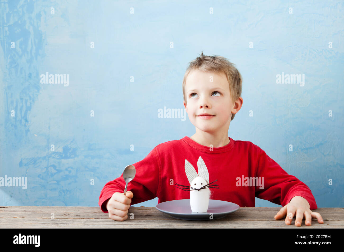 Boy with rabbit decoration on plate Stock Photo