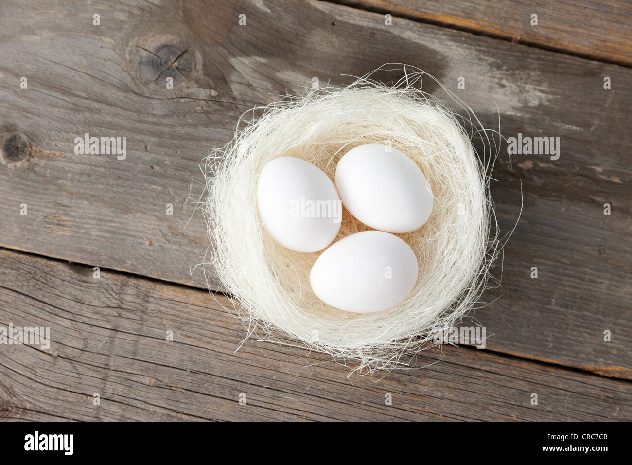Eggs in nest on wooden counter Stock Photo - Alamy