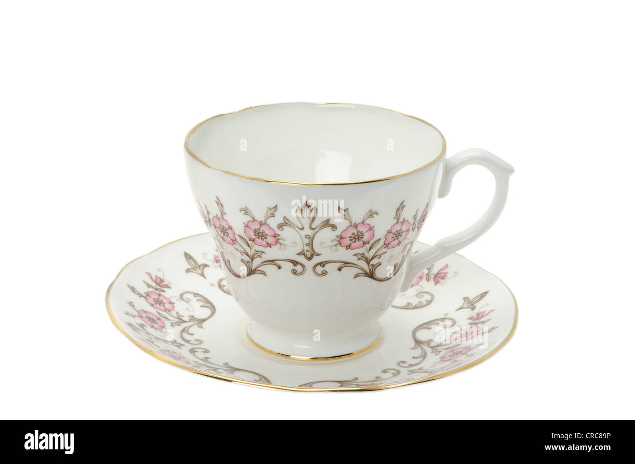An ornate patterned bone china tea cup and saucer on a white background - studio shot Stock Photo