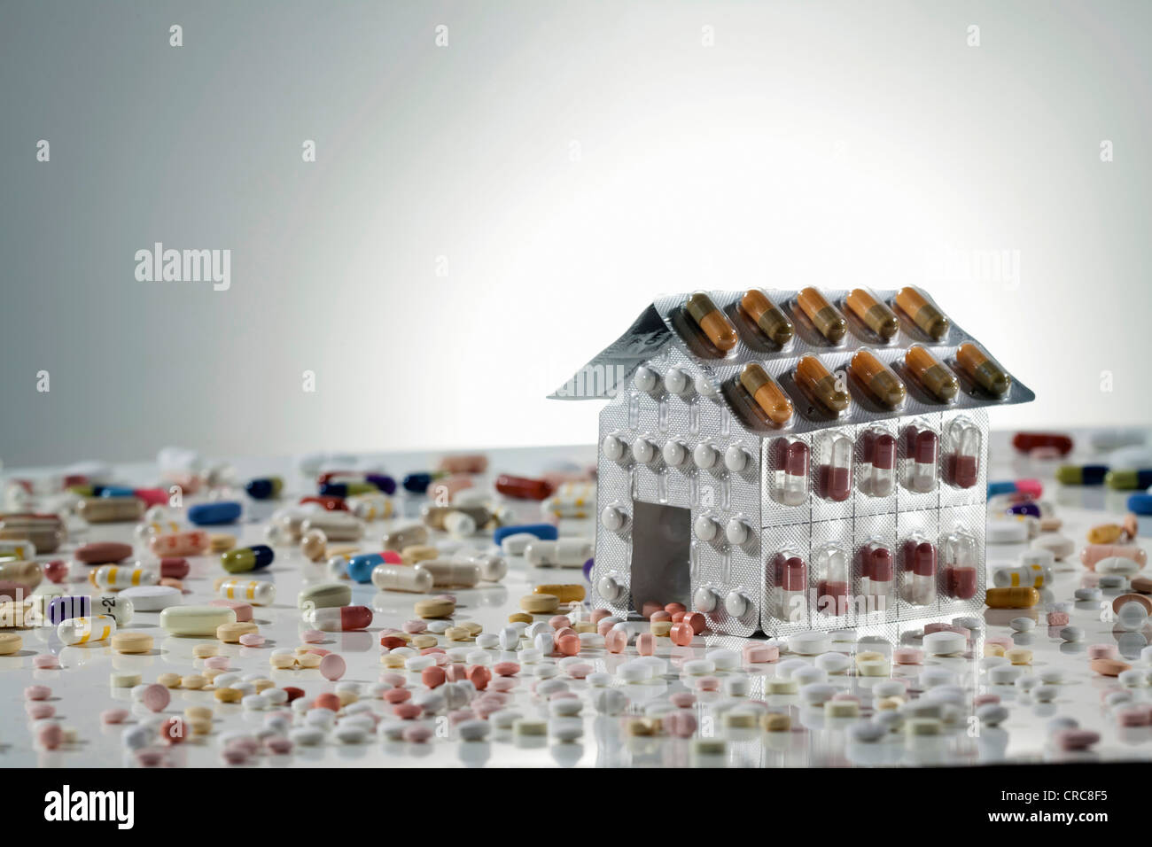 Blister packs of pills in shape of house Stock Photo