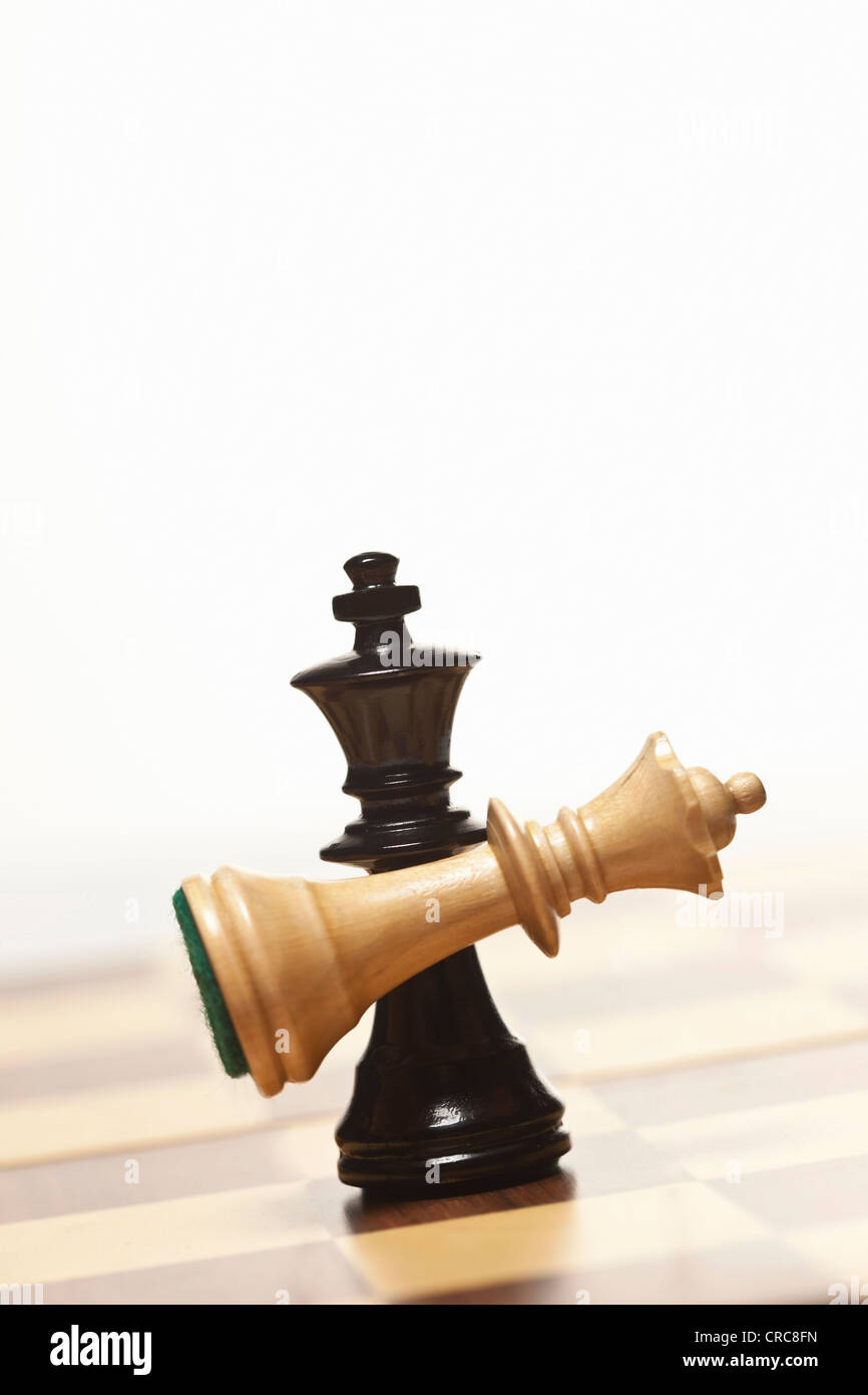 Black chess king holding white queen Stock Photo - Alamy