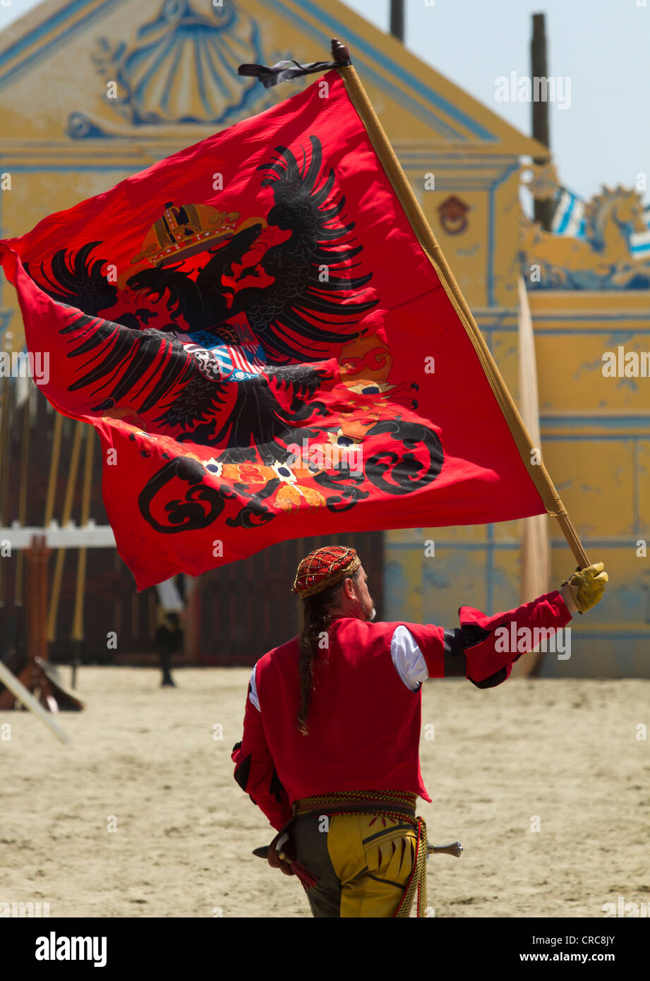 Flag bearer waving a flag from the Renaissance period Stock Photo
