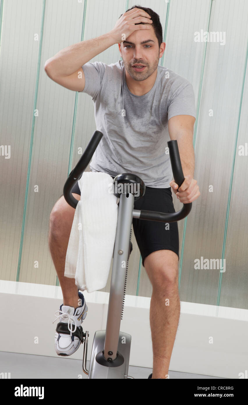 Struggling Man Using Exercise Machine Stock Photo Alamy