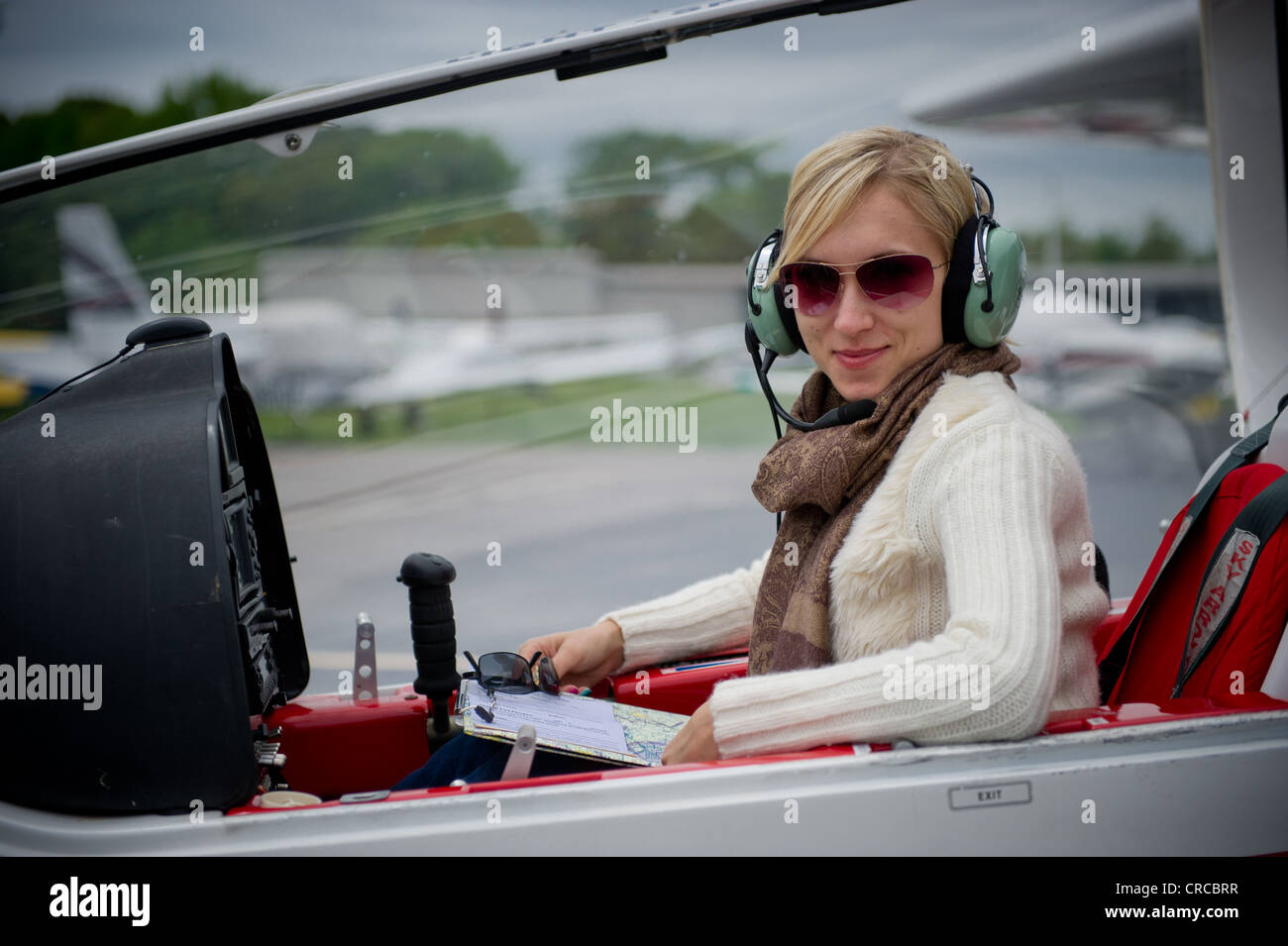 Female pilot in Sky Arrow light sport LSA aircraft Stock Photo