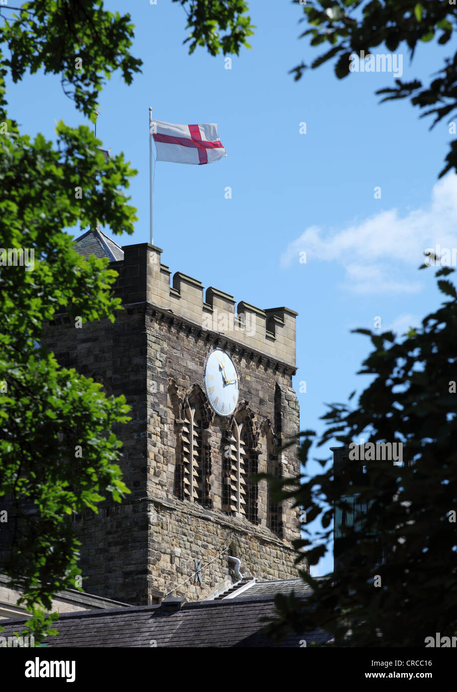St George's cross flying above the tower of Hexham Abbey Northumberland England UK Stock Photo