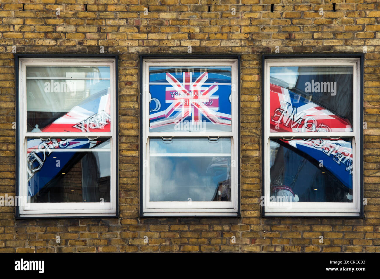 Carnaby street, union jack street sign reflected in 3 windows. London, England Stock Photo