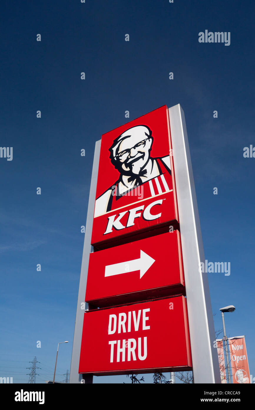 KFC Kentucky Fried Chicken Drive Thru red sign with Colonel Sanders on roadside with blue sky Cardiff Wales UK Stock Photo