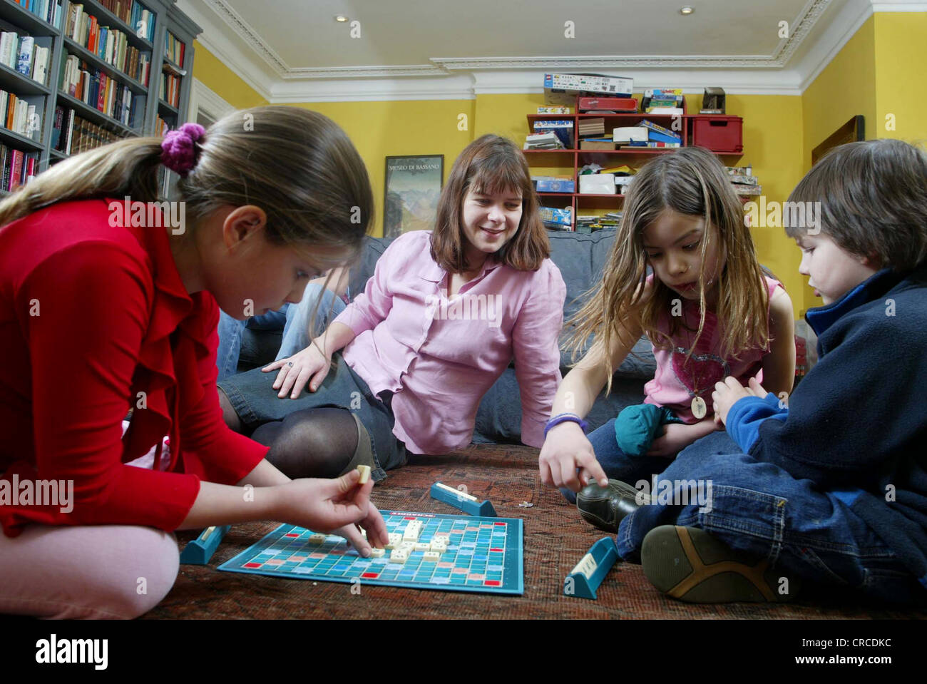 Family at home playing Scrabble board game, United Kingdom Stock Photo Alamy