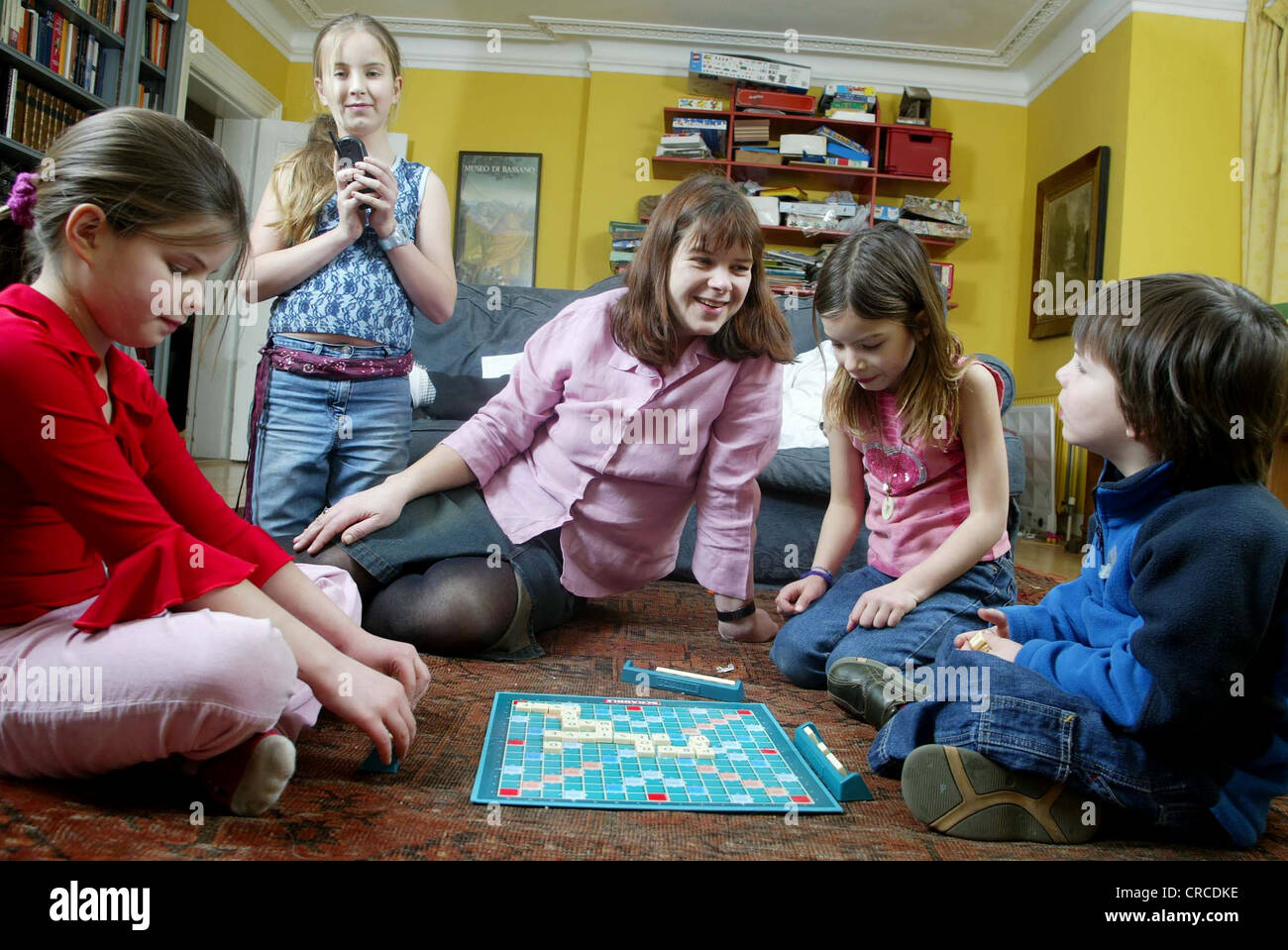 Family at home playing Scrabble board game, United Kingdom Stock Photo Alamy