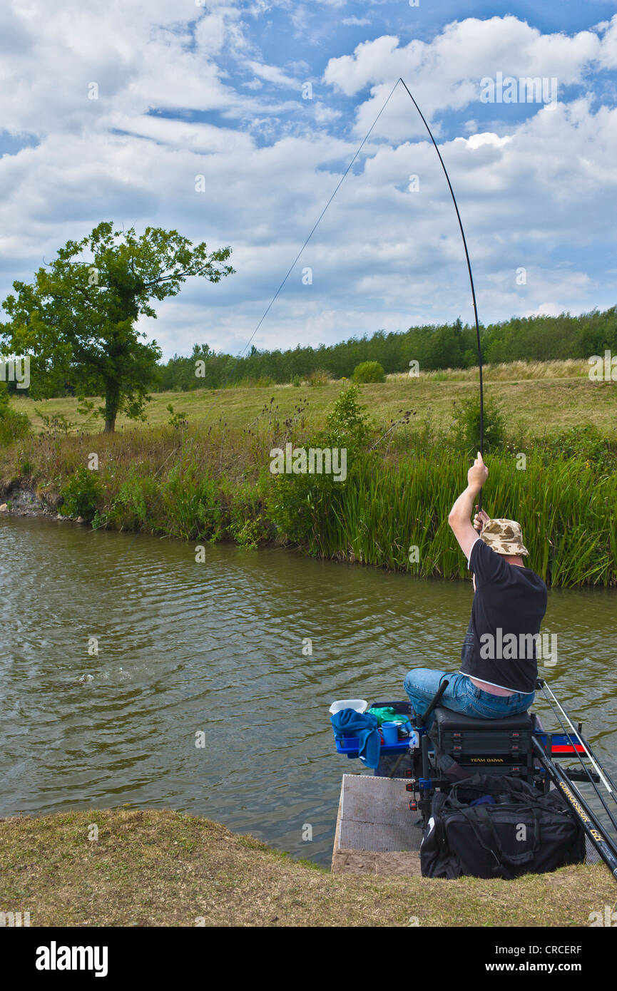 Man pole fishing for carp at Lake near Bagworth, Leicestershire Stock