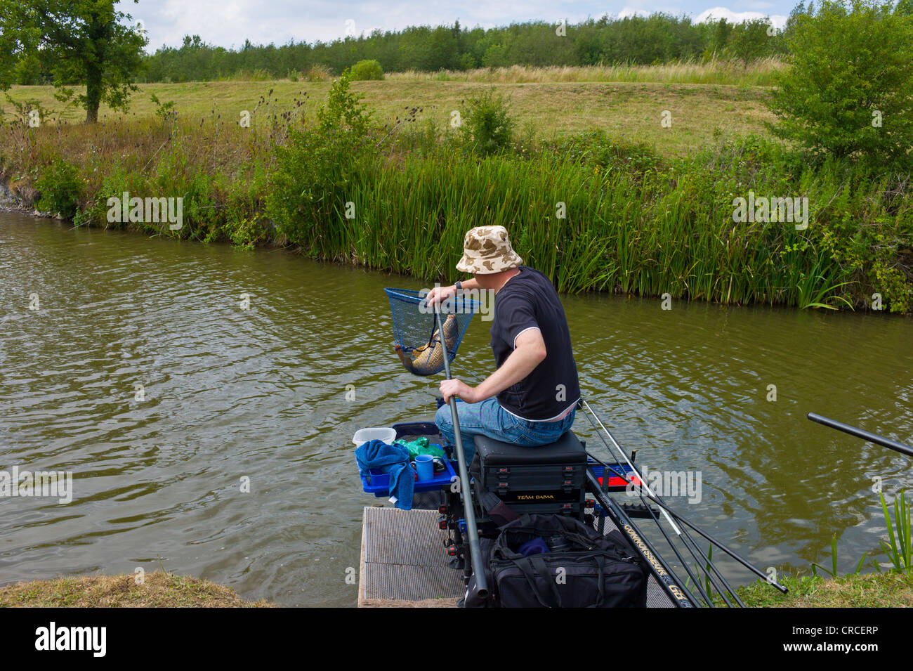 Man pole fishing for carp at Lake near Bagworth, Leicestershire