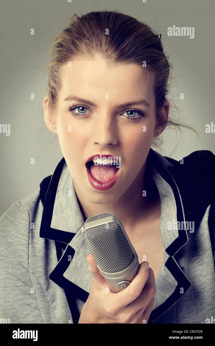 Young woman with a professional broadcast microphone Stock Photo