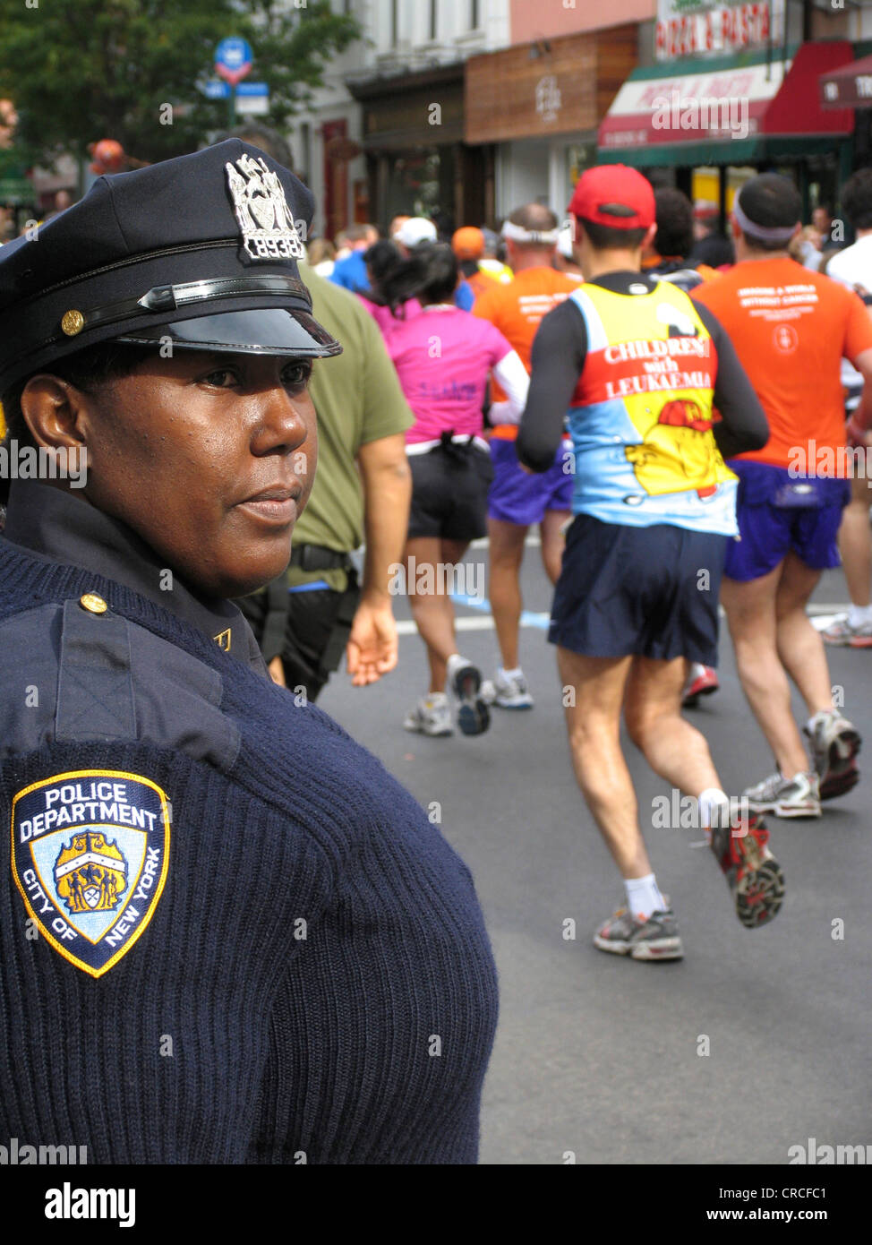 Police officer watching participants of the 2007 New York Marathon, USA, Brooklyn, New York City Stock Photo